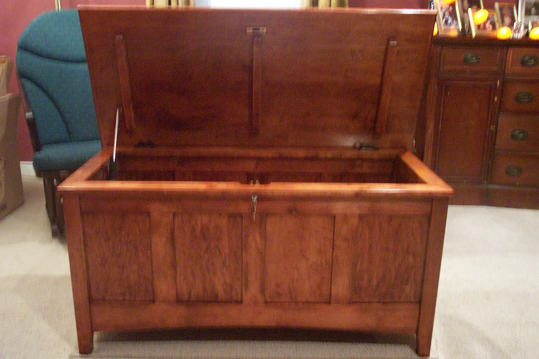Restored solid wood storage bench with four-panel front and lift-top lid, cherry finish
